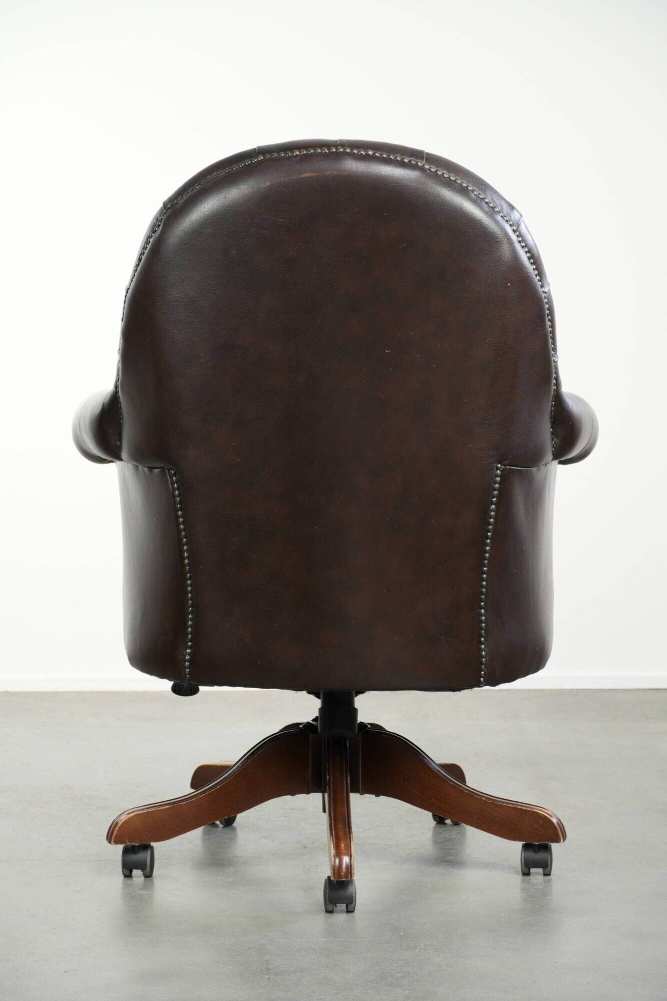 Brown cow leather Chesterfield office chair on wheels in English style