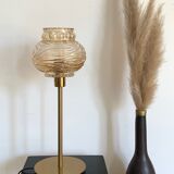 Table lamp with an antique textured globe and a golden base