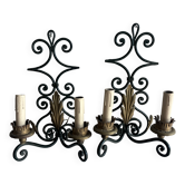 Pair of wall sconces in wrought iron with golden leaf patterns.