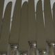 Set of 12 knives with silver metal handles and stainless steel blades.