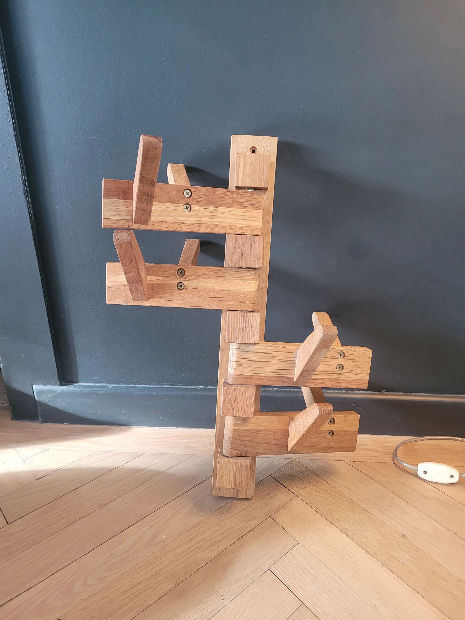 Articulated vertical wall coat rack