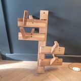 Articulated vertical wall coat rack