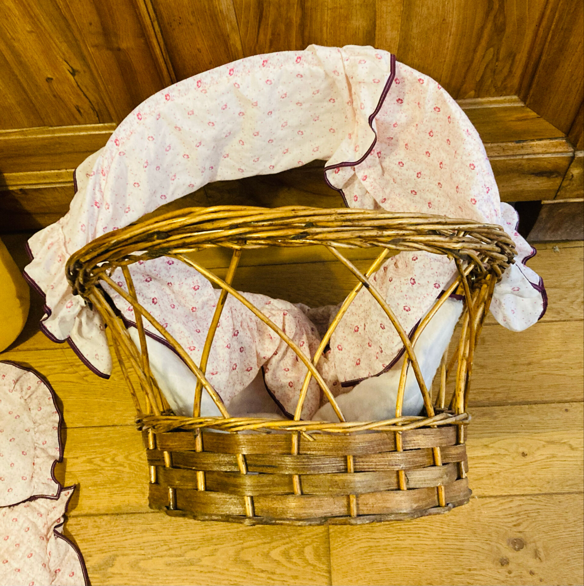1960s wicker cradle with mattress and drapes.