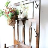 Antique brown wooden coat rack with mirror and umbrella stand, 1900 style.