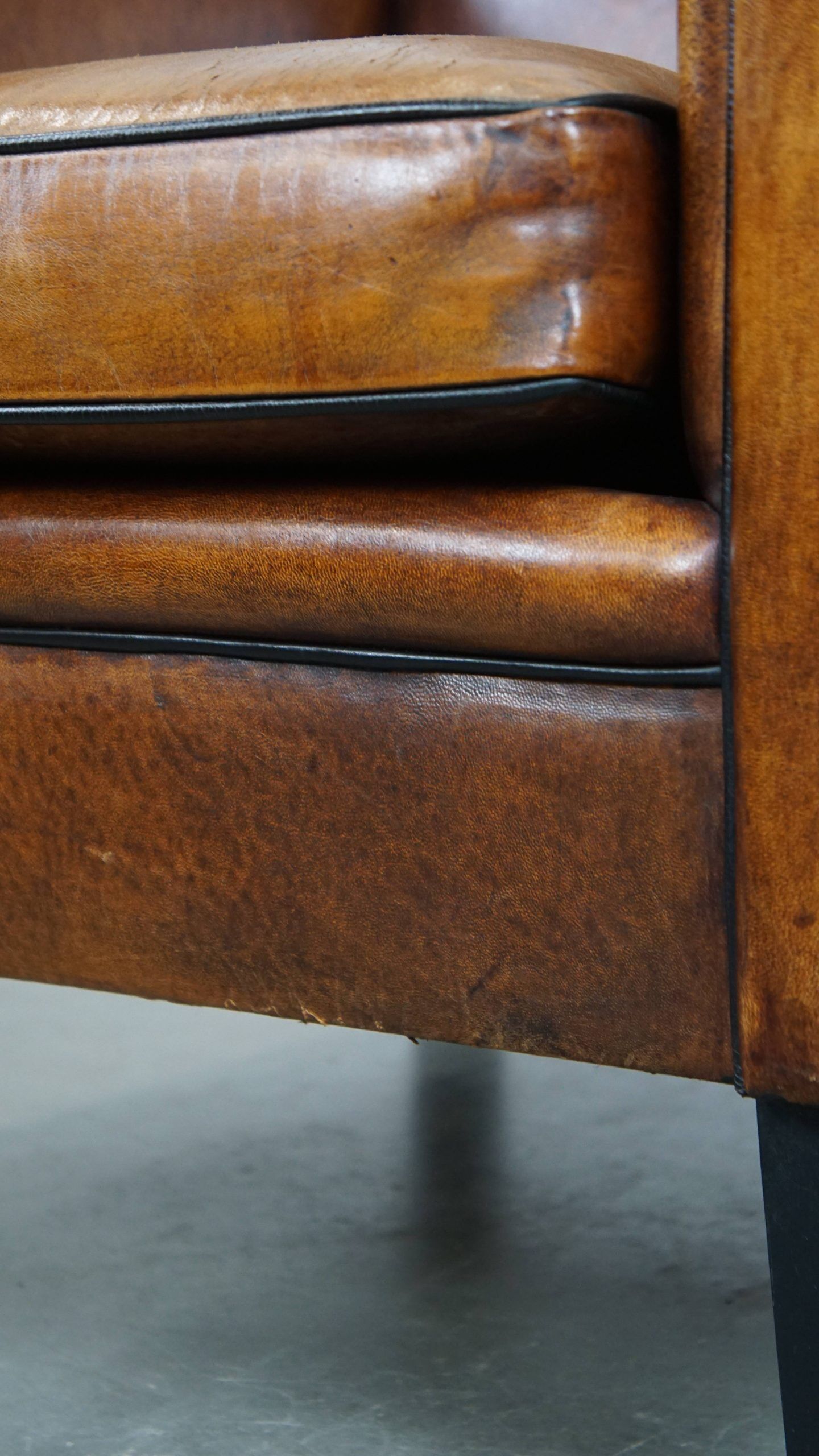 Sheepskin Art Deco design armchair with sleek finish and black piping