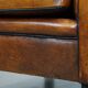 Sheepskin Art Deco design armchair with sleek finish and black piping
