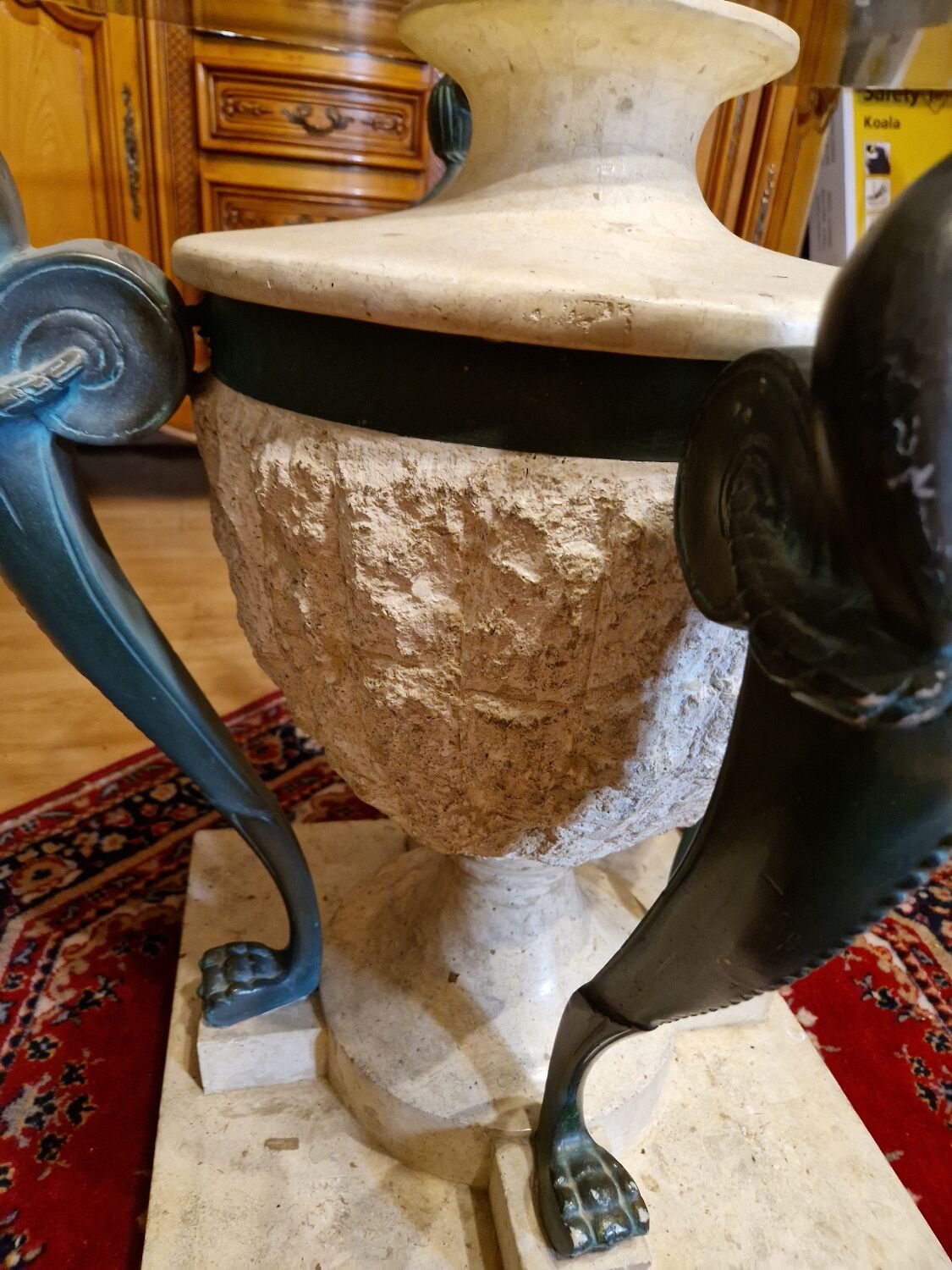 Stone and bronze dining table with ribbed glass top