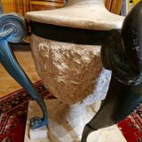 Stone and bronze dining table with ribbed glass top