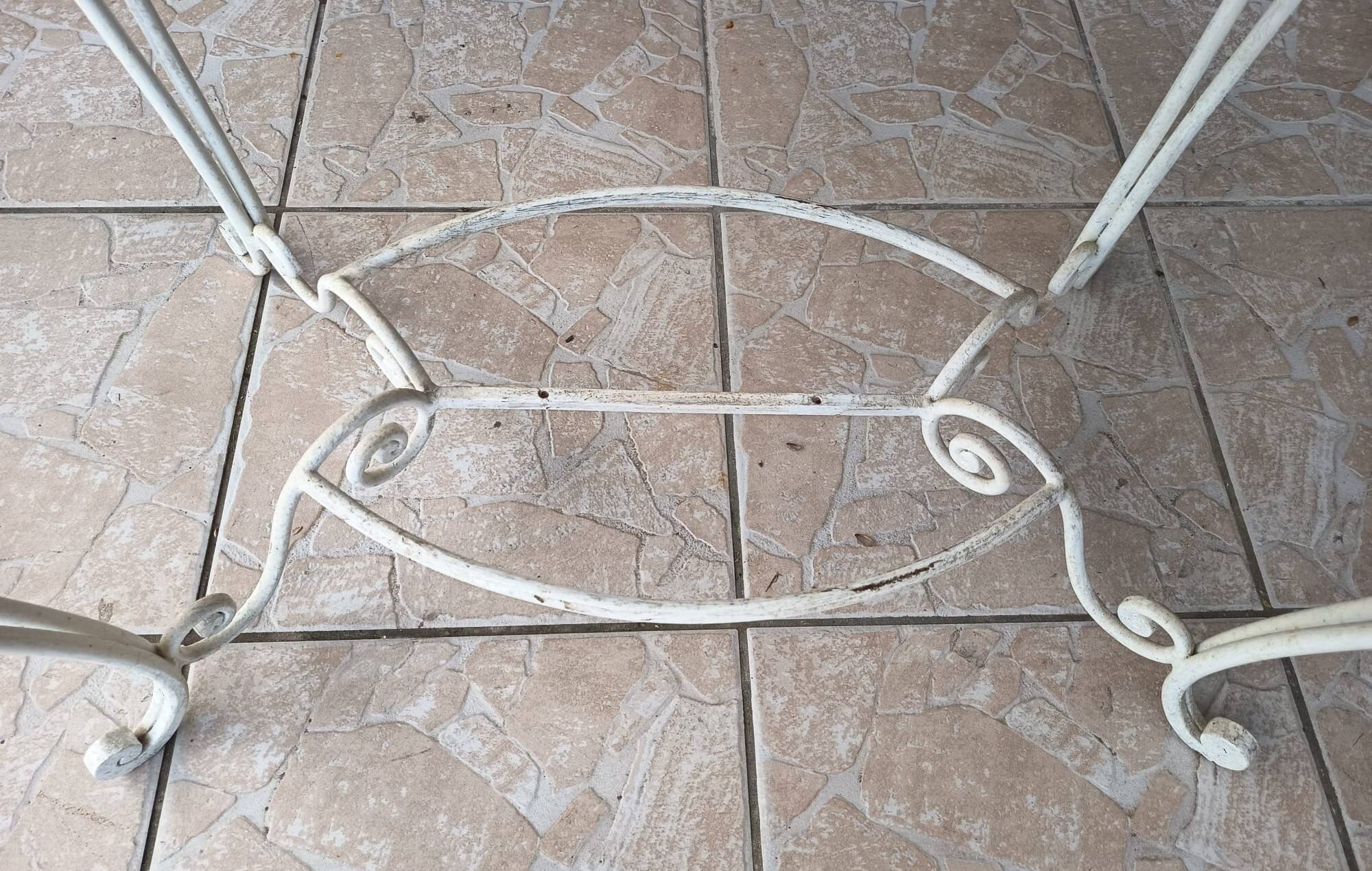 Wrought iron table with a walnut top.