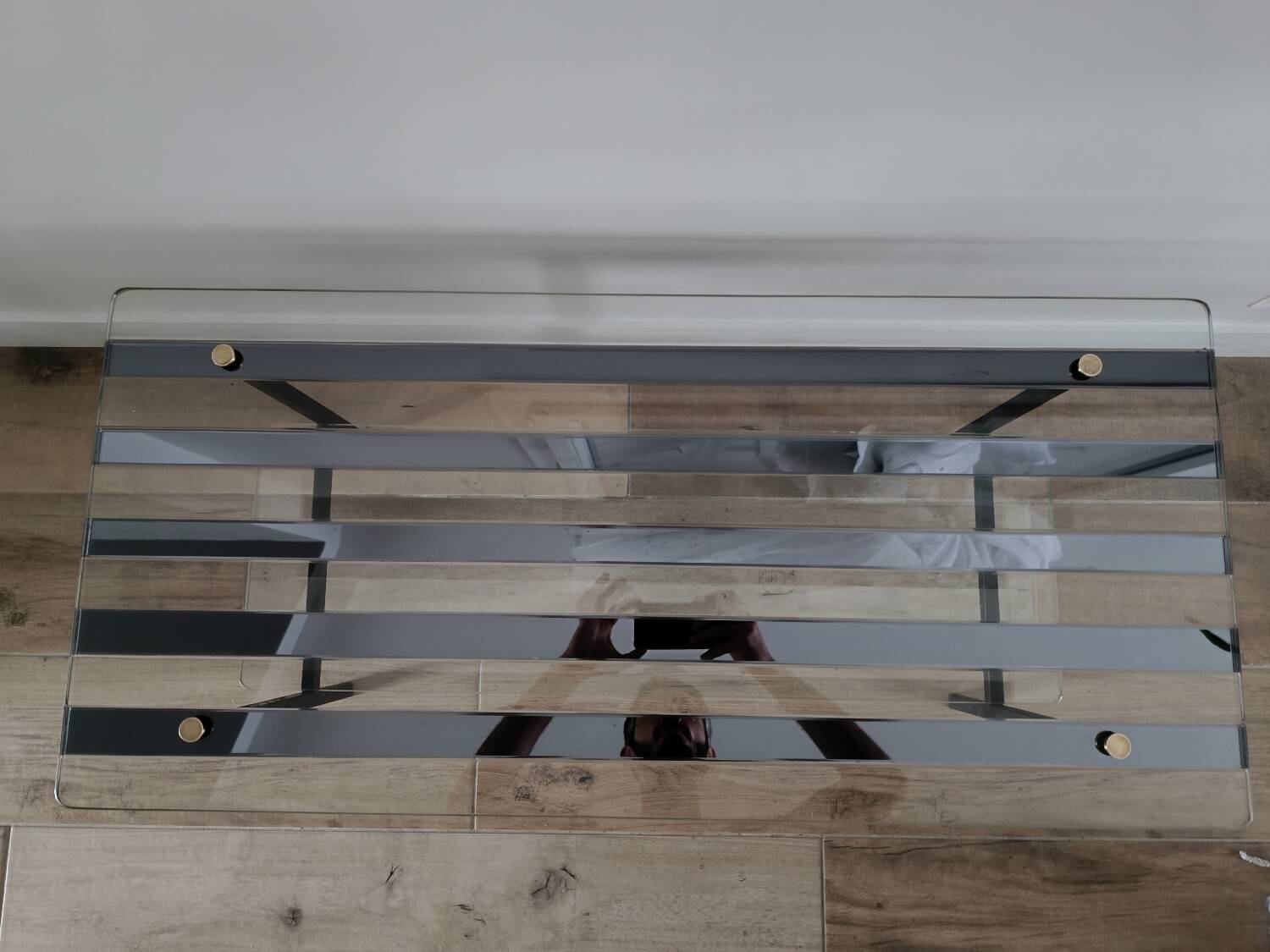 Vintage coffee table in glass and mirror strips.