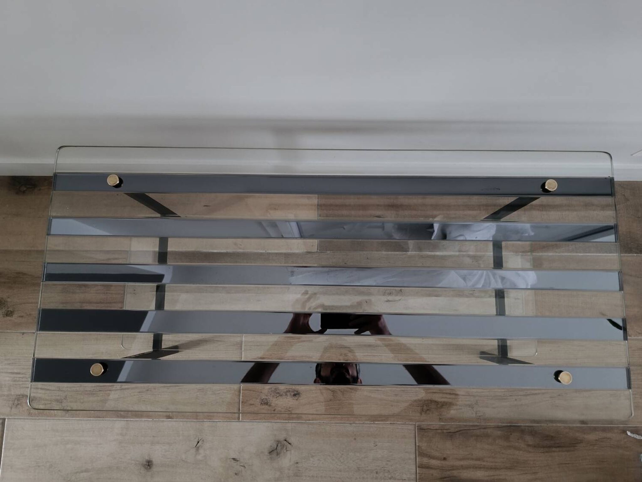 Vintage coffee table in glass and mirror strips.