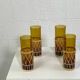 Vintage service for orangeade in amber glass and wicker.