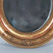Antique oval mirror with original stucco and gilt wood frame, 37x31 cm. Beautiful patina.