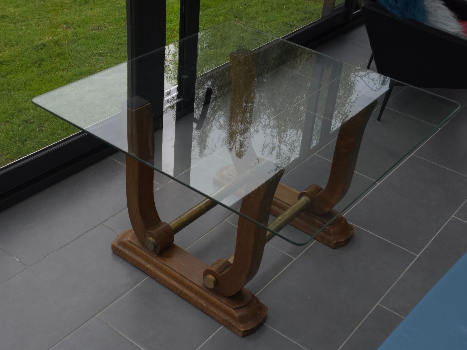 Art Deco coffee table in glass, wood, and brass.