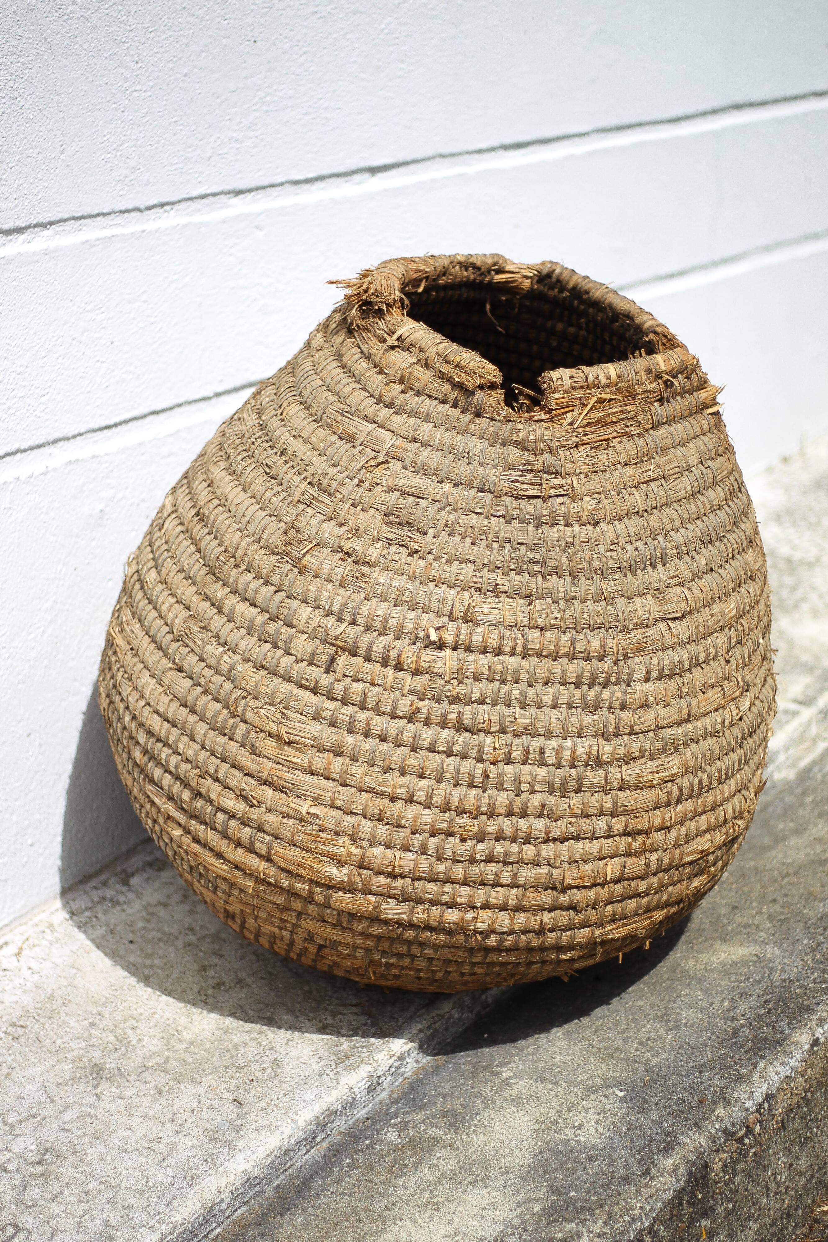 Old basket, burgundy straw and bramble, woven basket, interior decoration, pantry, flowerpot