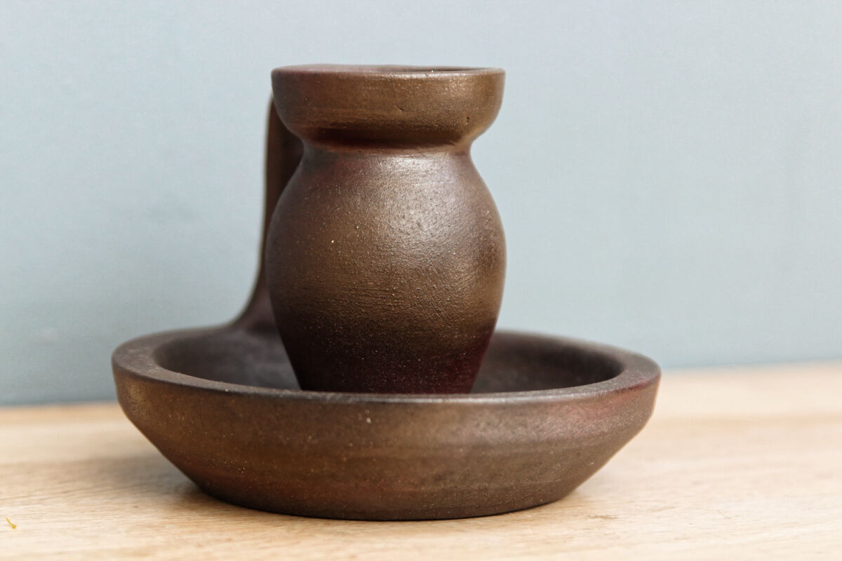 Small hand-held candlestick, signed