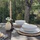 Restored solid wood round table with integrated extensions.