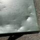 Folding garden or bistro table in khaki sheet metal from the early 1950s.