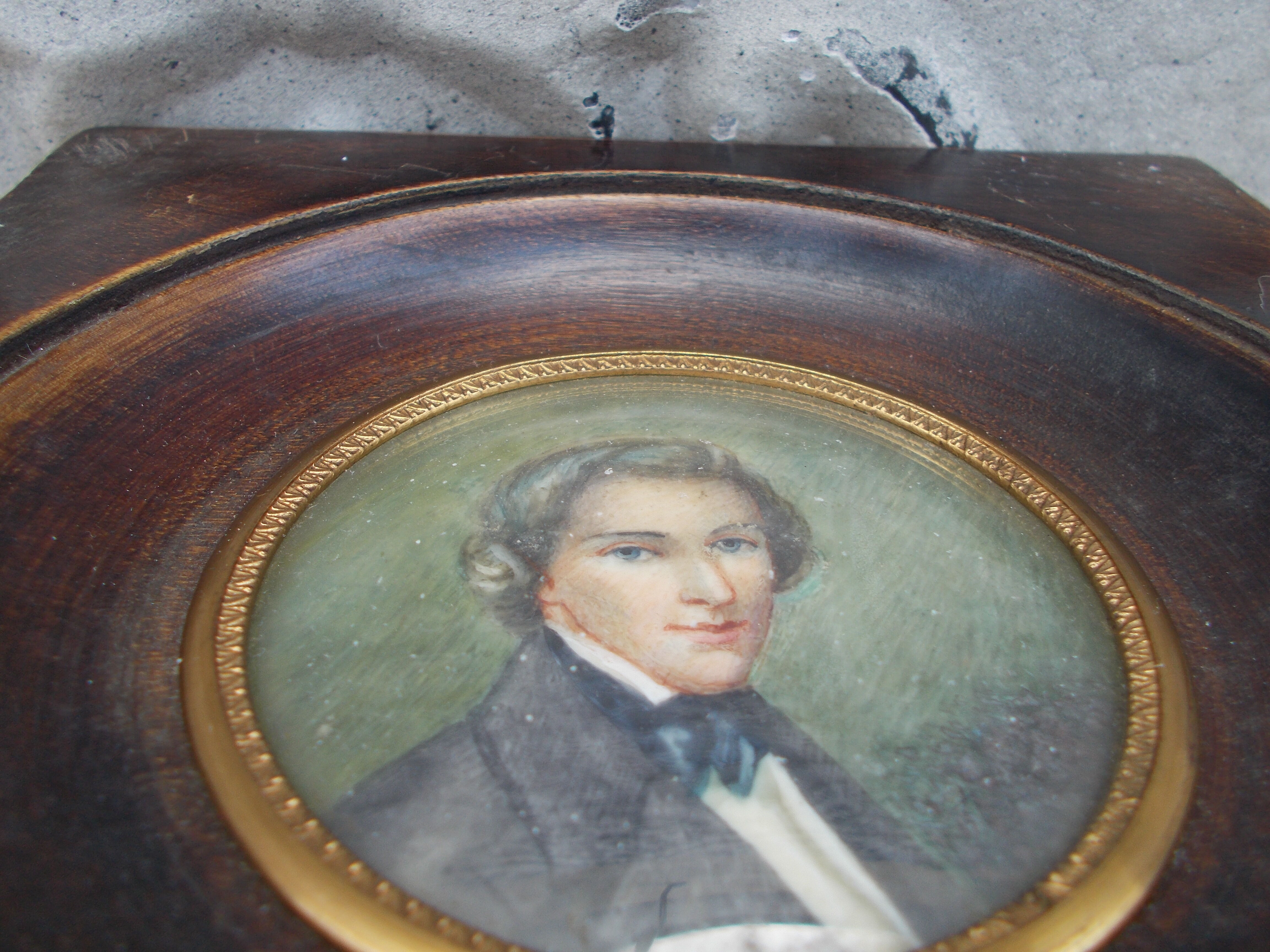 Miniature portrait of a man in a wooden frame