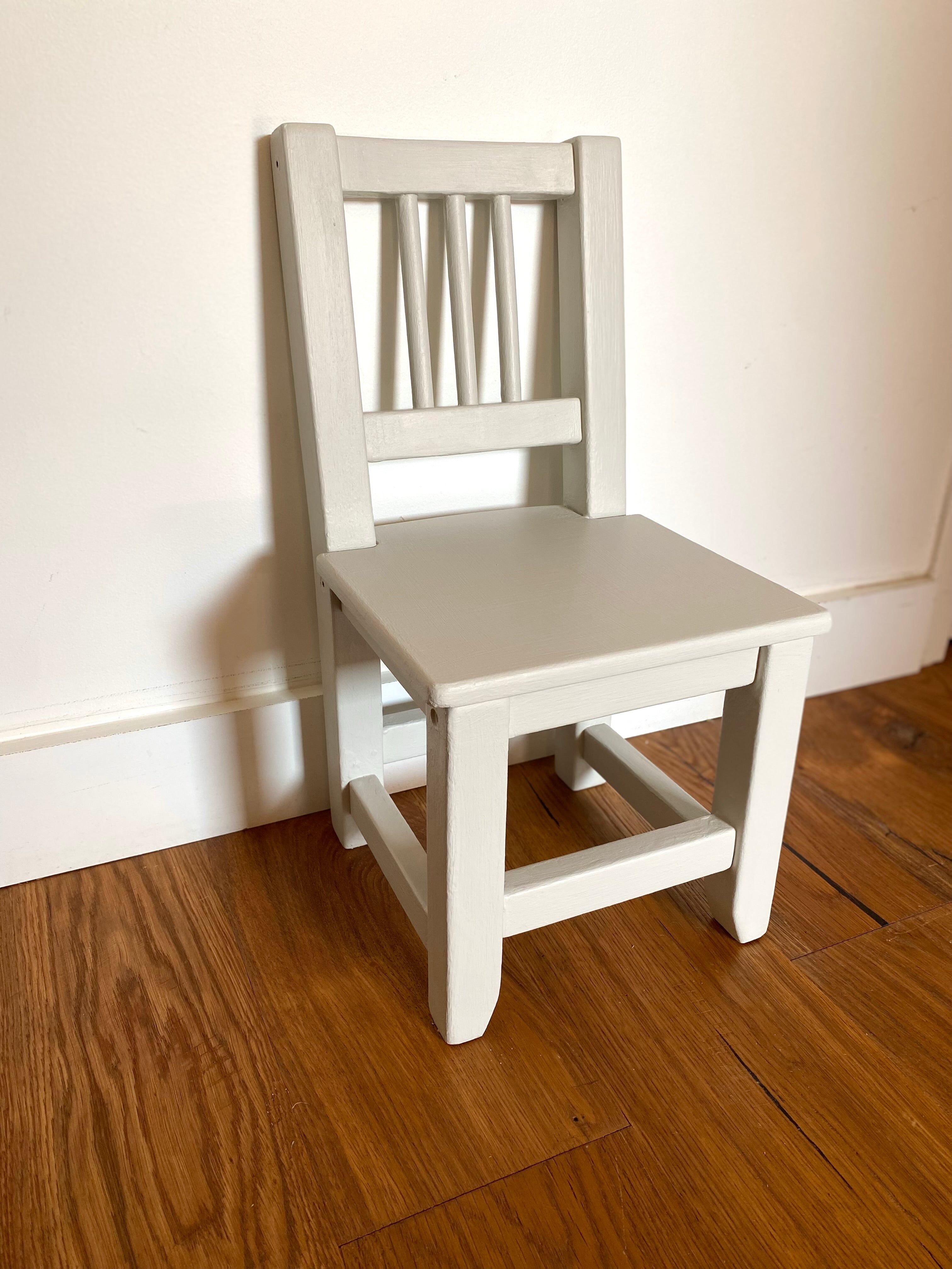 Small children's chair in antique white wood.