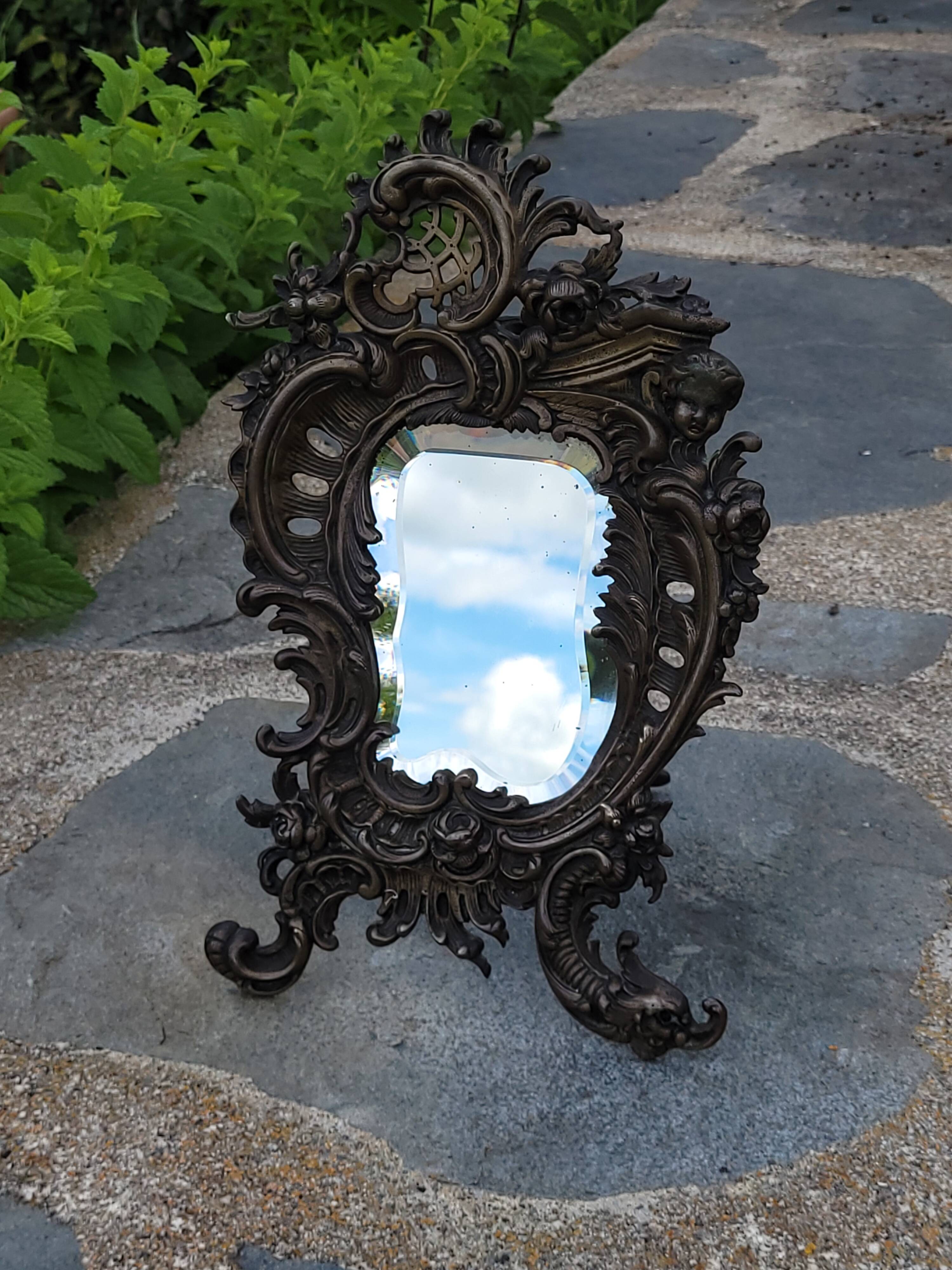 Antique bevelled bronze table mirror on stand, late 19th century.