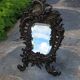 Antique bevelled bronze table mirror on stand, late 19th century.