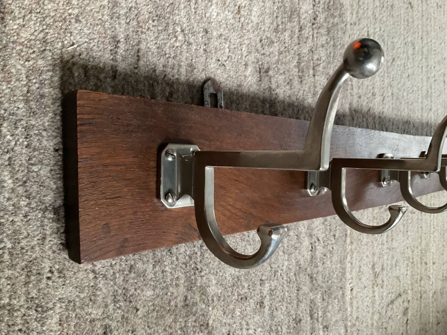 Wall coat rack from the 1950s-60s in solid oak and stainless steel.