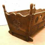 Sculpted walnut rocking cradle