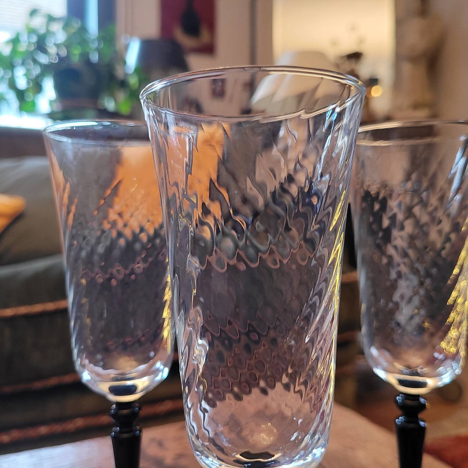 4 clear glass flutes with black stems. 1960–1970. 4 clear glass flutes with black stems.