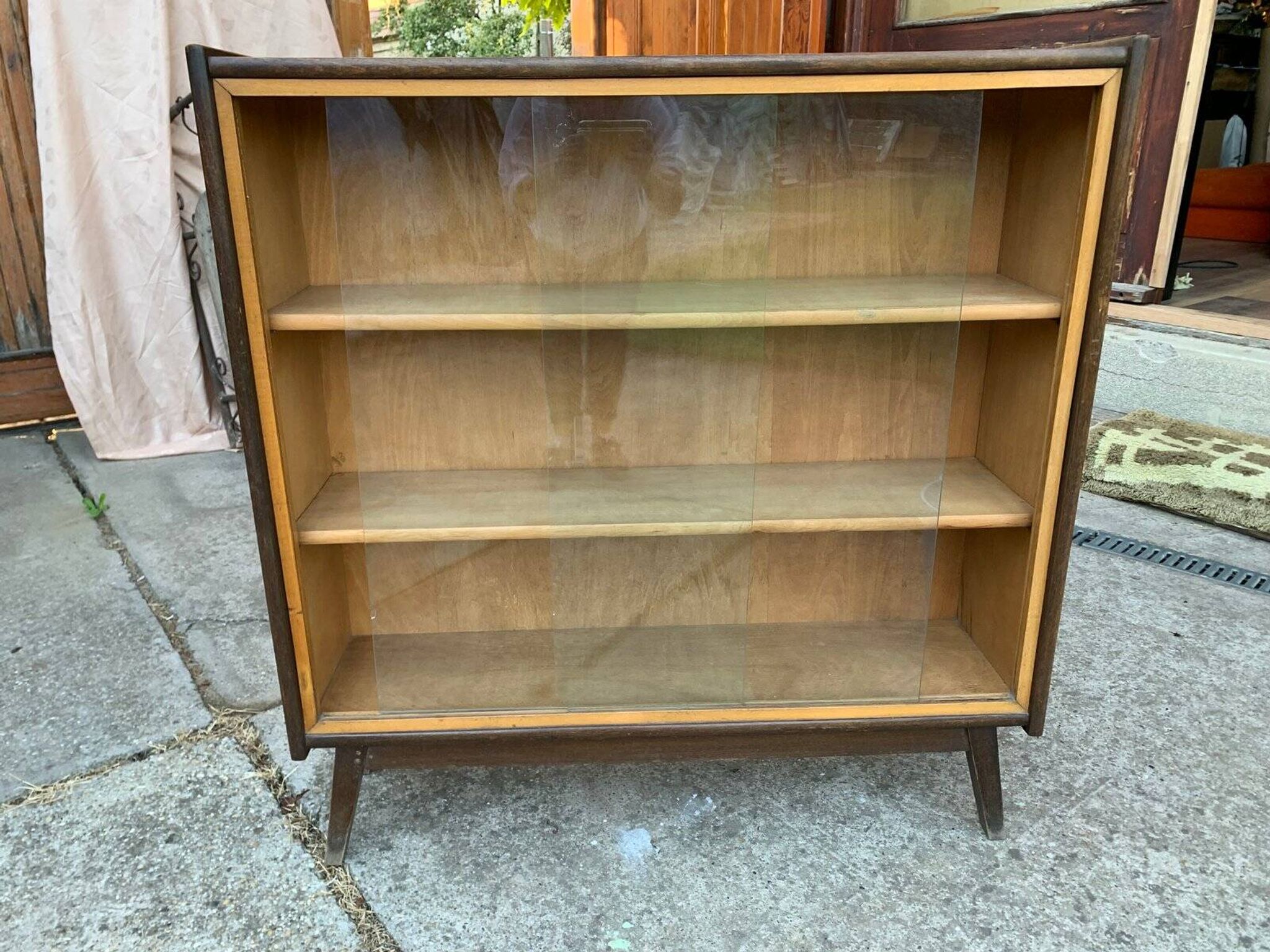 Mid-century brown wooden library (beech & pine) with glass doors from the 1960s.