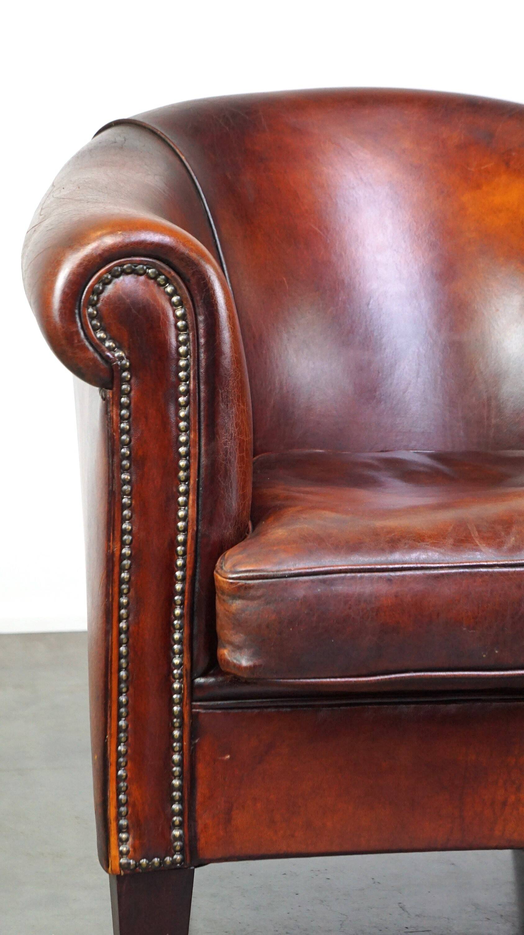 Very luxurious dark brown sheepskin club chair with a more than beautiful patina