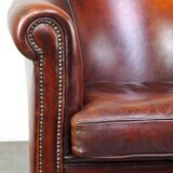 Very luxurious dark brown sheepskin club chair with a more than beautiful patina