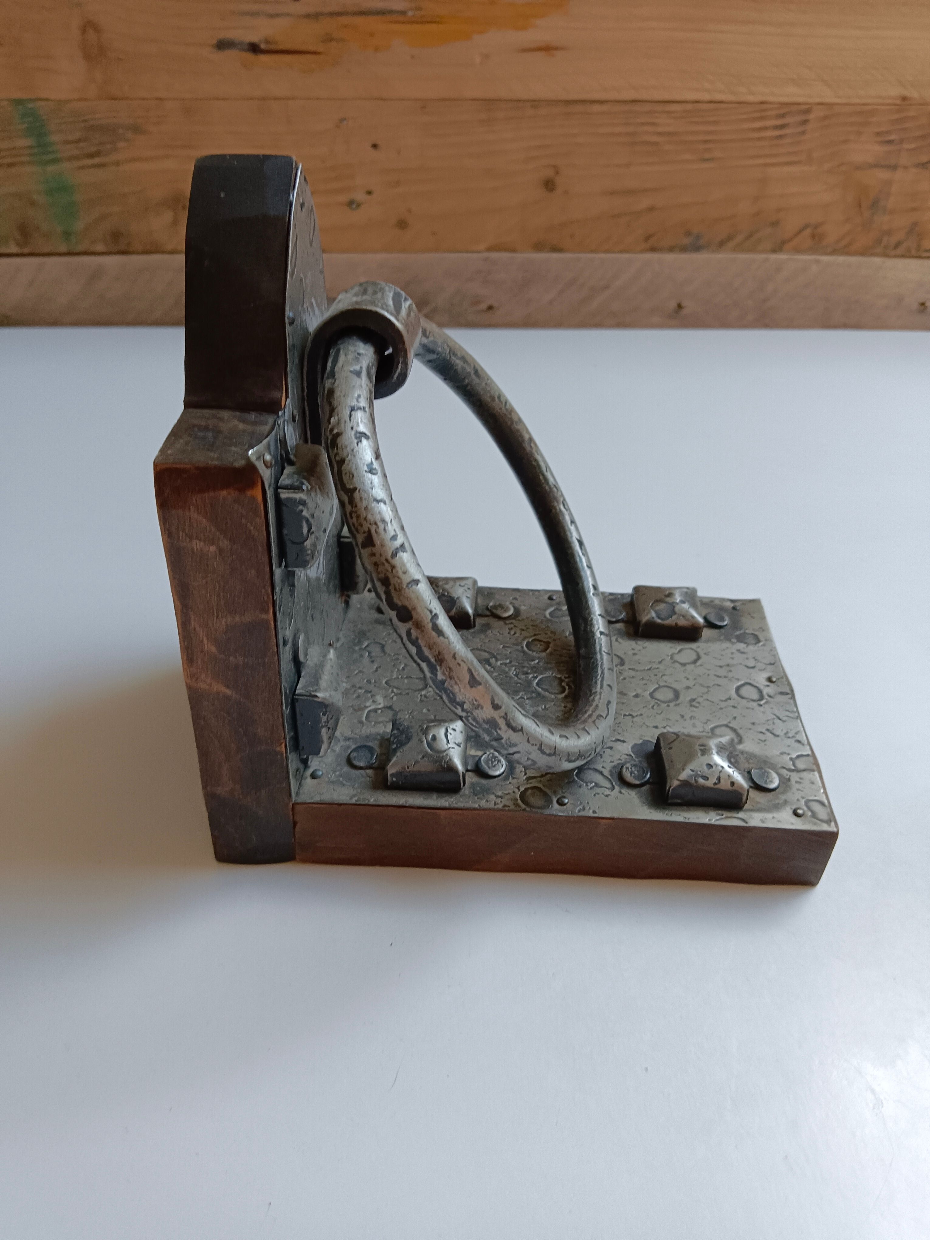 Medieval-style bookends, antique door handle.