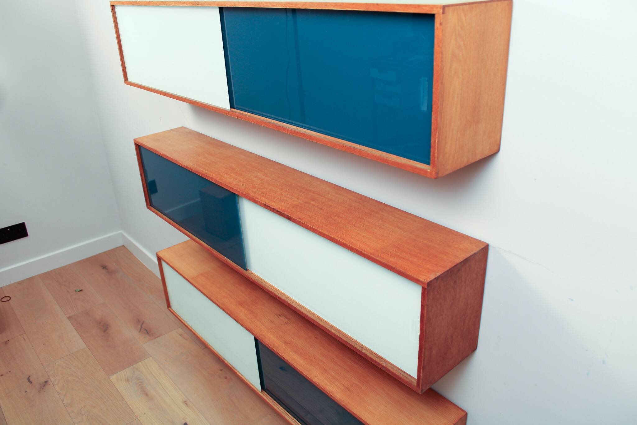 Vintage mid-century wall hung oak cabinets, blue & white sliding glass door