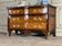 Louis XV style commode in rosewood and palisander veneer, gilt bronze mounts, and Rance marble top.