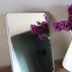 Simple rectangular barber mirror with a stand.