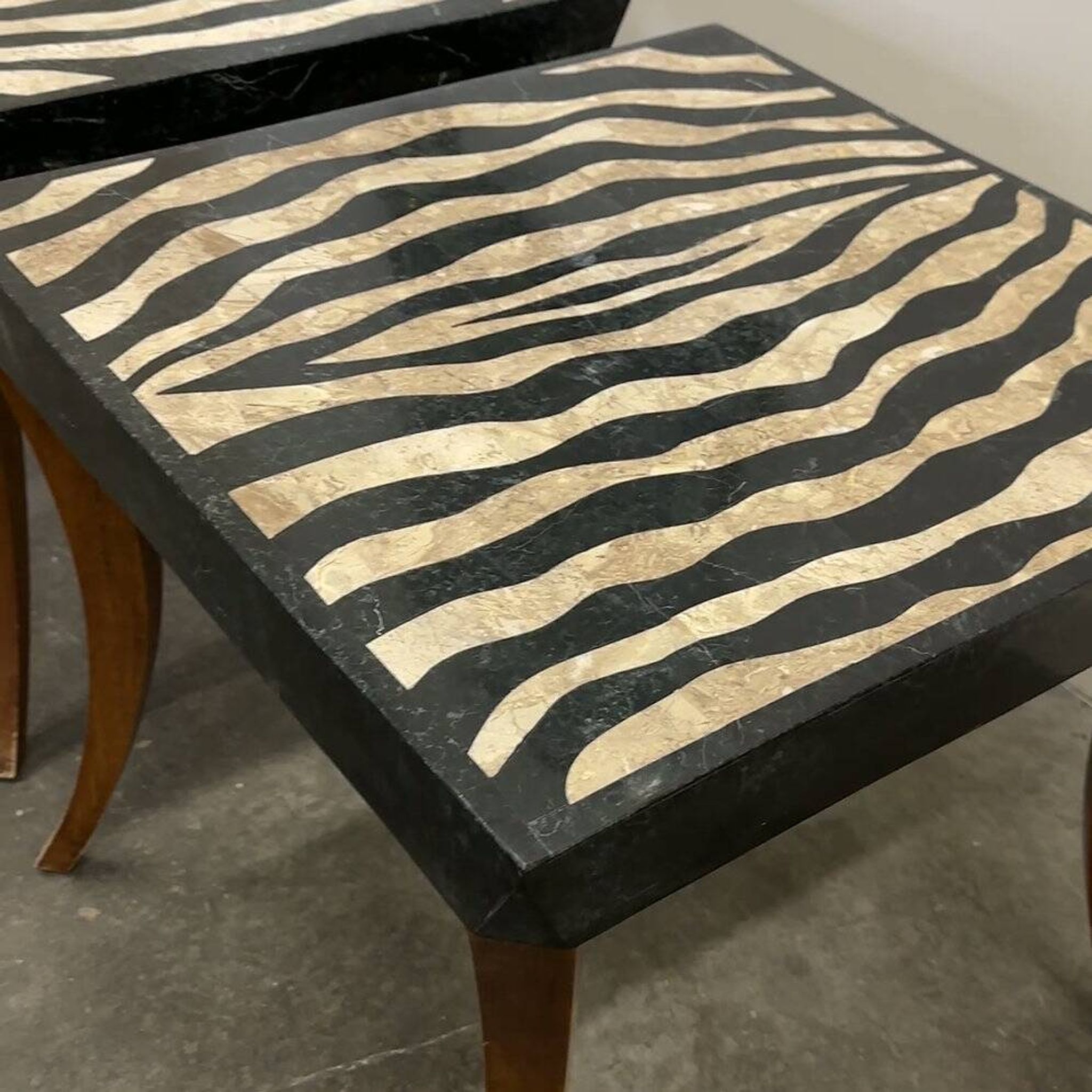 Striking pair of Italian zebra inlaid tessellated stone tables with refined curves