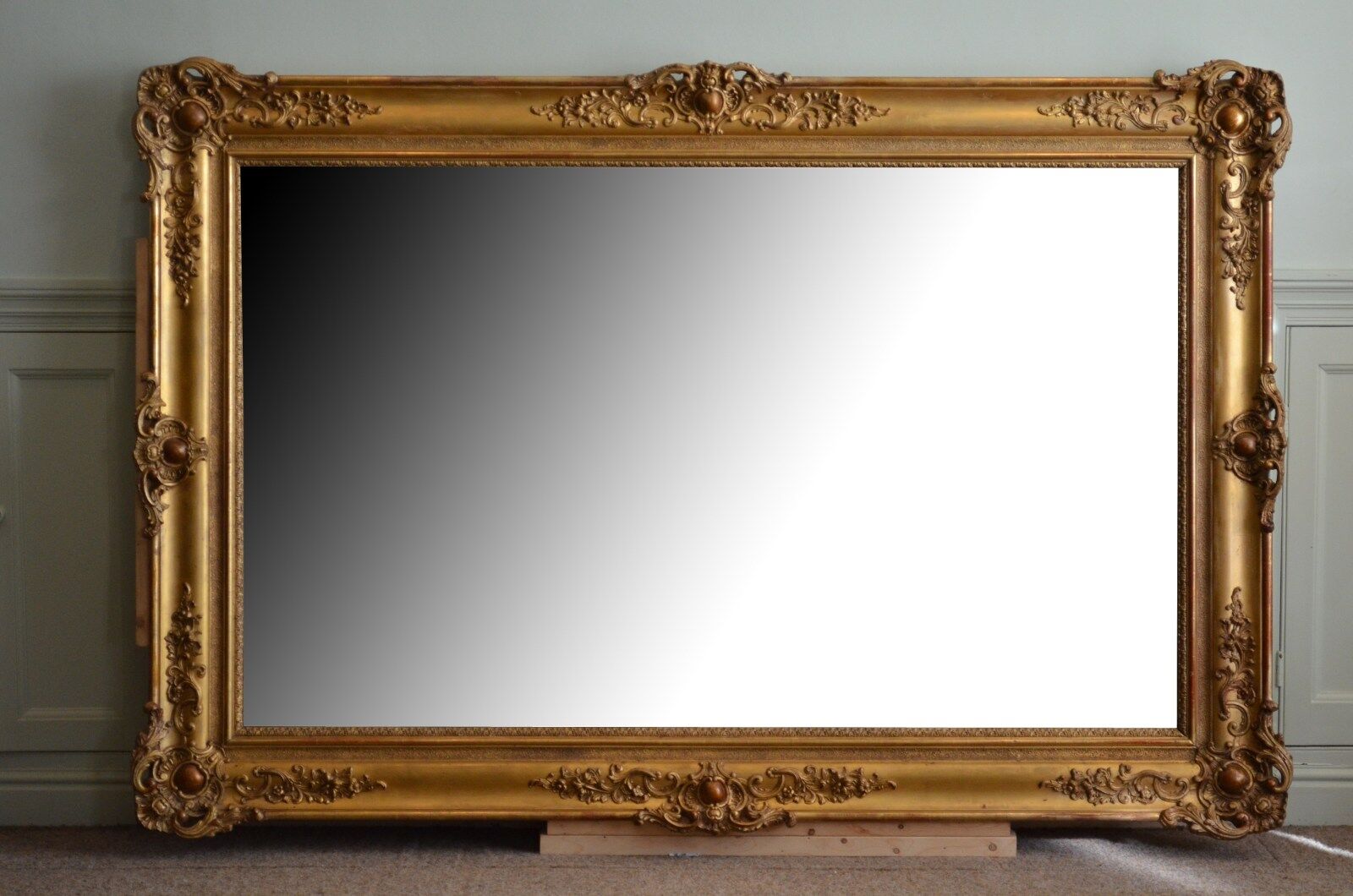 Nineteenth century monumental mirror in gilded wood