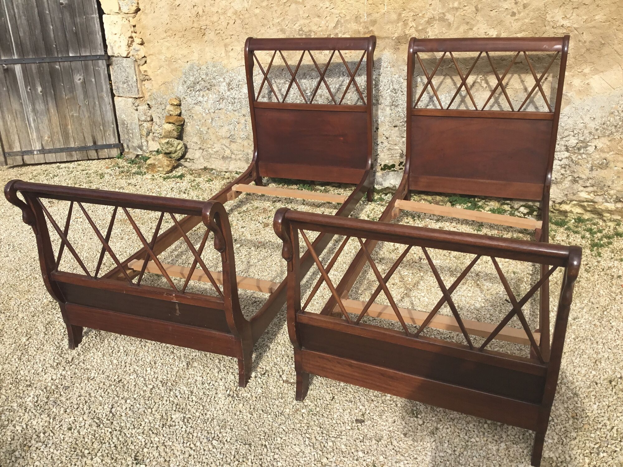 Pair of twin swan collar empire-style beds in mahogany XXth