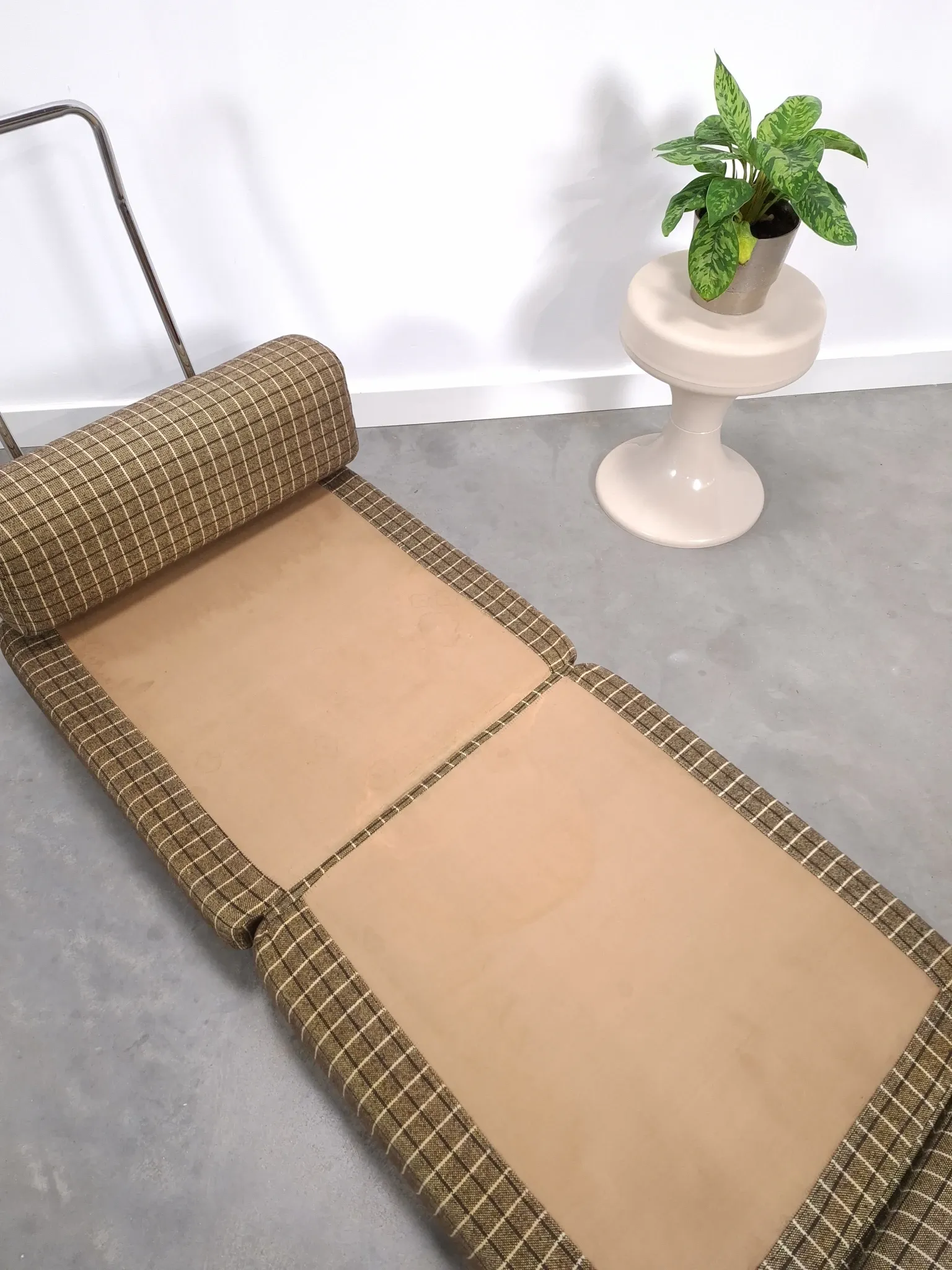 Vintage pull-out sofa bed, brown checked lounge chair with chrome.