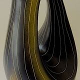 Earthenware vase decorated with yellow lines on a black and yellow background