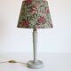 Table lamp, turned wooden base and antique printed lampshade