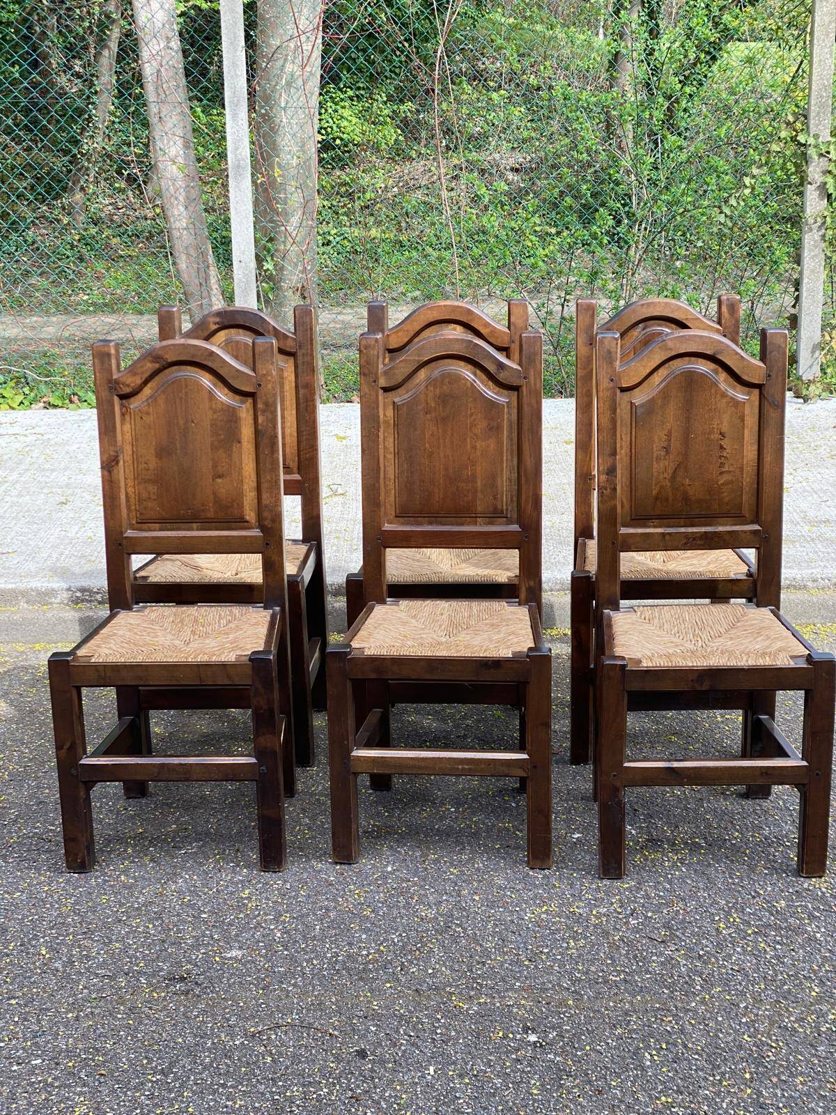 6 dining chairs in a country or farmhouse style, made of dark solid wood and rush-seated.