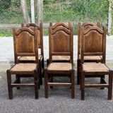 6 dining chairs in a country or farmhouse style, made of dark solid wood and rush-seated.