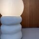 Large table lamp in off-white ceramic with an organic globe shape.