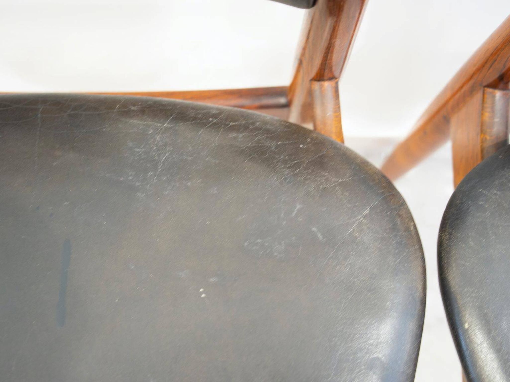 Set of four Arne Vodder chairs in hardwood and black leather.