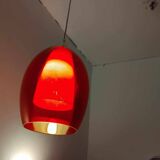 Pair of conical pendant lights in red tinted glass