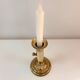 Old brass candlestick with push button.