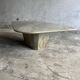 Light gray solid granite coffee table with organic triangular shape and conical base, 1980s