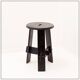 Vintage black-stained wooden tripod stool with mortise joints.
